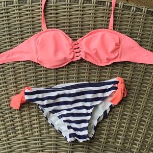 Bright pink swimsuit with navy striped bottoms